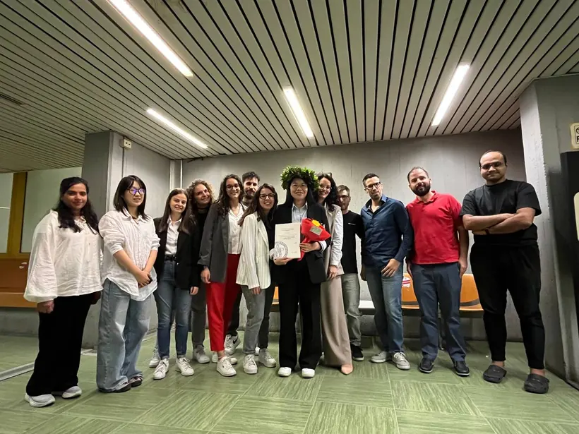 Researchers celebrating a university graduation milestone · 2026