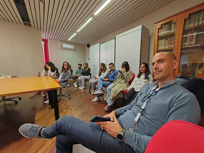 Colleagues gathered in an academic meeting room